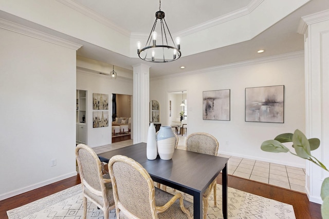 dining area featuring ornate columns, a chandelier, crown molding, wood finished floors, and recessed lighting