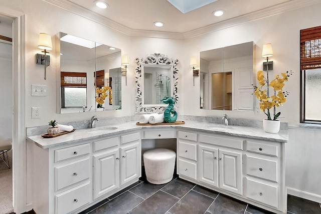 full bathroom with double vanity, ornamental molding, recessed lighting, tile patterned floors, and a skylight