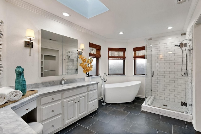 full bathroom featuring a shower stall, ornamental molding, vanity, tile patterned floors, and a skylight