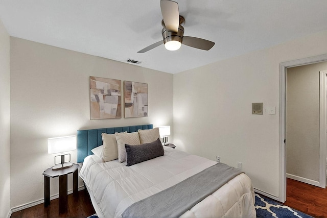 bedroom with wood finished floors, baseboards, and ceiling fan