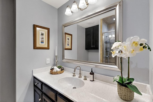 bathroom with vanity and a shower with door