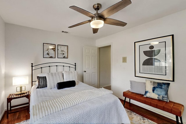 bedroom with baseboards, wood finished floors, and a ceiling fan