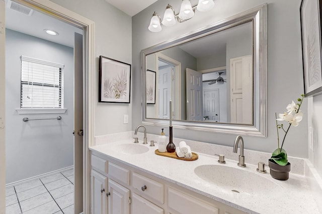 bathroom with tile patterned floors, double vanity, and ceiling fan