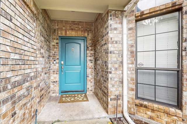 property entrance with brick siding
