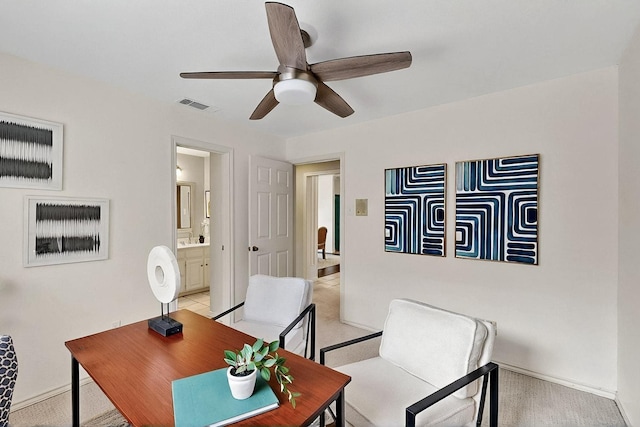 office featuring ceiling fan, baseboards, and light colored carpet