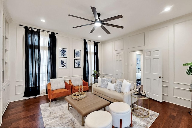 living area featuring a decorative wall, a ceiling fan, dark wood-style flooring, and recessed lighting