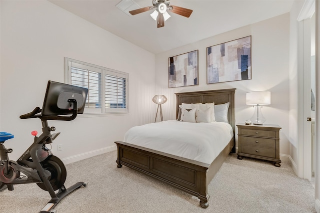 bedroom featuring baseboards, ceiling fan, and light carpet