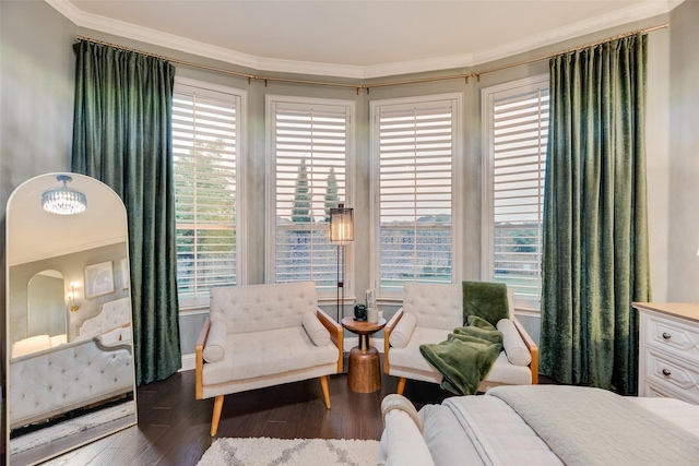 bedroom with crown molding, baseboards, and wood finished floors