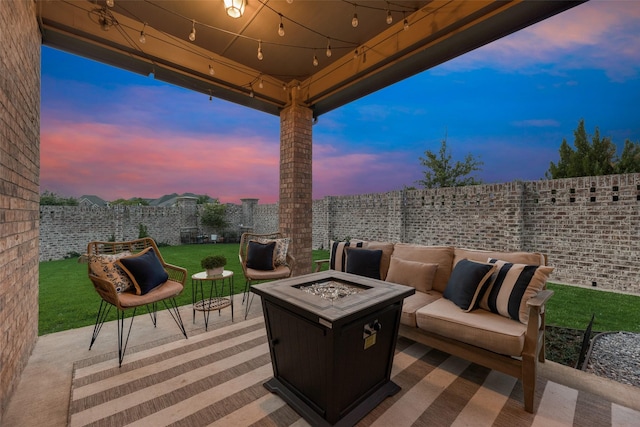 view of patio / terrace with a fenced backyard and an outdoor living space with a fire pit