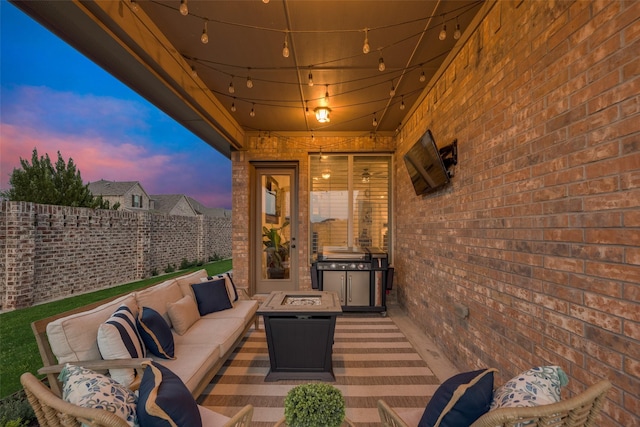 view of patio with an outdoor living space with a fire pit and fence