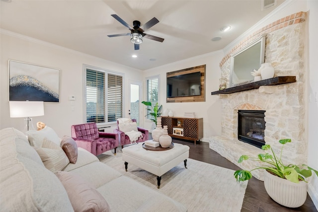 living room featuring crown molding, ceiling fan, wood finished floors, and visible vents