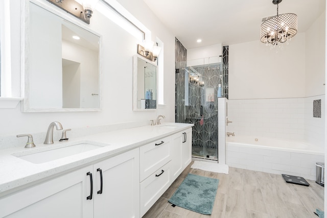 full bath featuring a garden tub, a sink, double vanity, and a shower stall