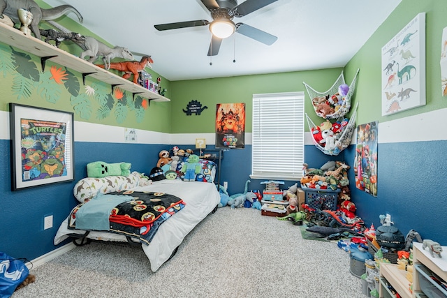 carpeted bedroom featuring ceiling fan and baseboards