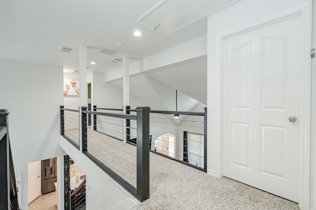 corridor with recessed lighting and attic access