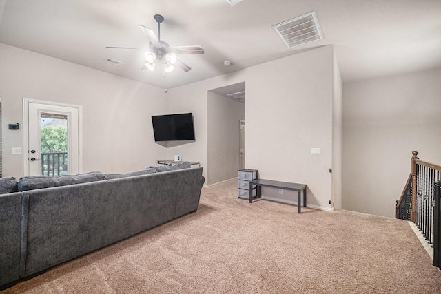 carpeted living room featuring a ceiling fan and baseboards