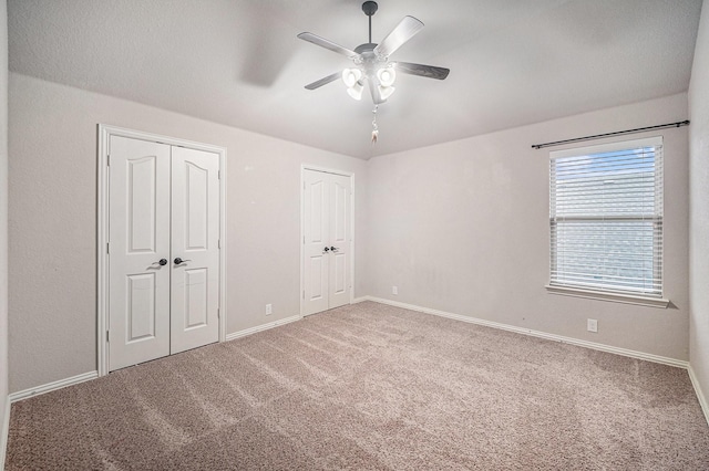 1137 Cardinal Ridge Rd, Burleson, TX 76028 - unfurnished bedroom with carpet flooring, multiple closets, baseboards, and ceiling fan