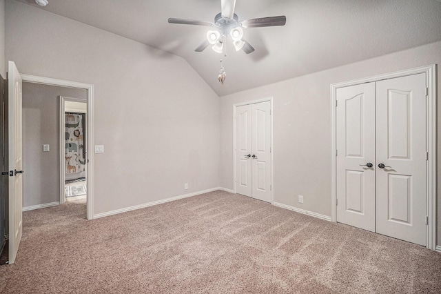 1137 Cardinal Ridge Rd, Burleson, TX 76028 - unfurnished bedroom featuring two closets, vaulted ceiling, carpet floors, baseboards, and ceiling fan