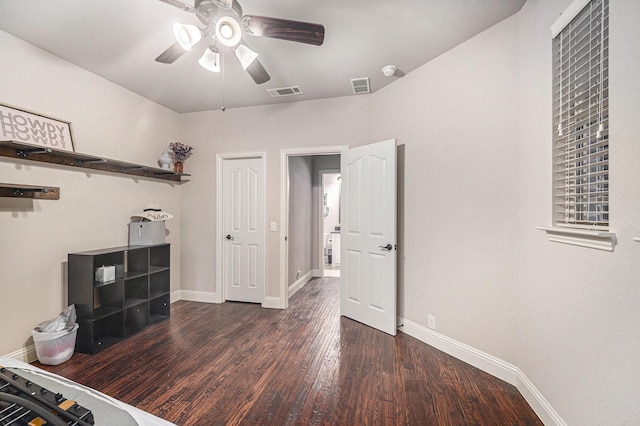 unfurnished office featuring ceiling fan, wood finished floors, and baseboards