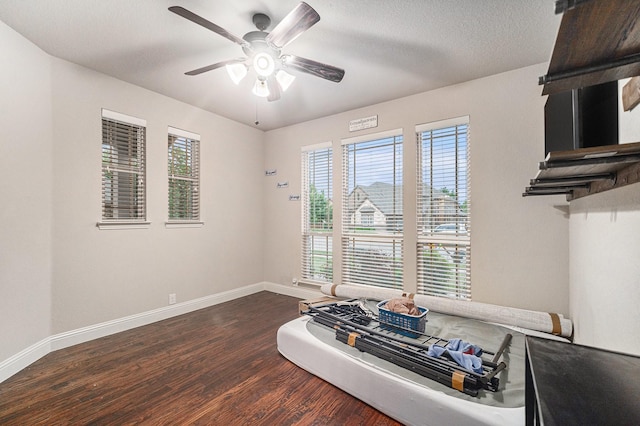 dining area with dark wood-style flooring, baseboards, and a ceiling fan