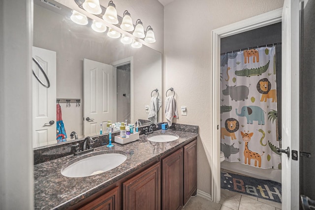 full bath with double vanity, tile patterned flooring, toilet, and shower / tub combo