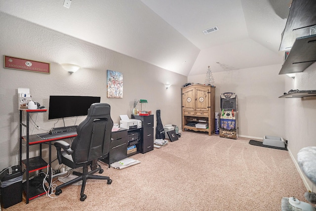 carpeted home office with lofted ceiling