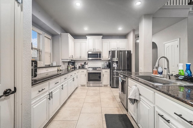 1137 Cardinal Ridge Rd, Burleson, TX 76028 - kitchen with appliances with stainless steel finishes, a sink, decorative backsplash, white cabinets, and light tile patterned floors