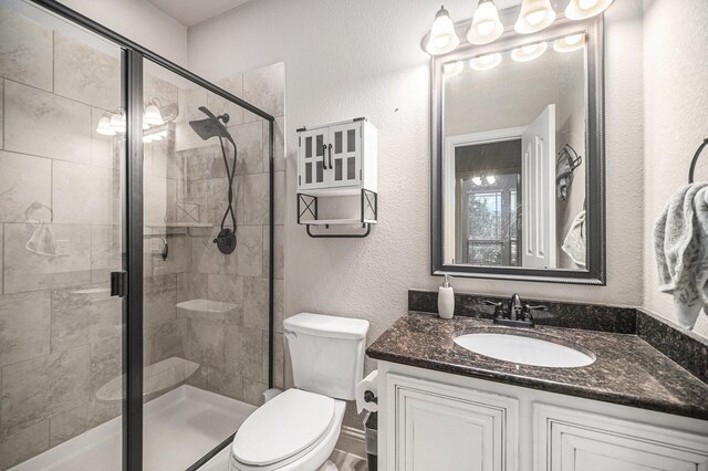 1137 Cardinal Ridge Rd, Burleson, TX 76028 - bathroom featuring toilet, vanity, a shower stall, and a textured wall
