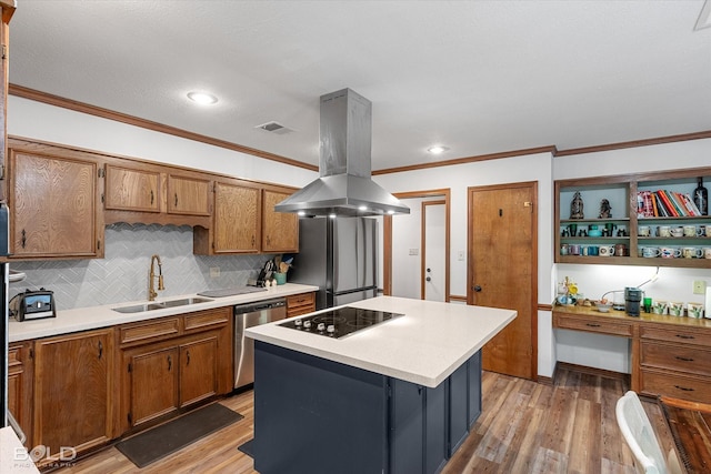 kitchen with a sink, light wood-style flooring, stainless steel appliances, island range hood, and visible vents