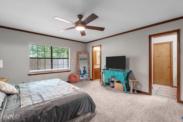 carpeted bedroom with crown molding, baseboards, ensuite bathroom, and ceiling fan