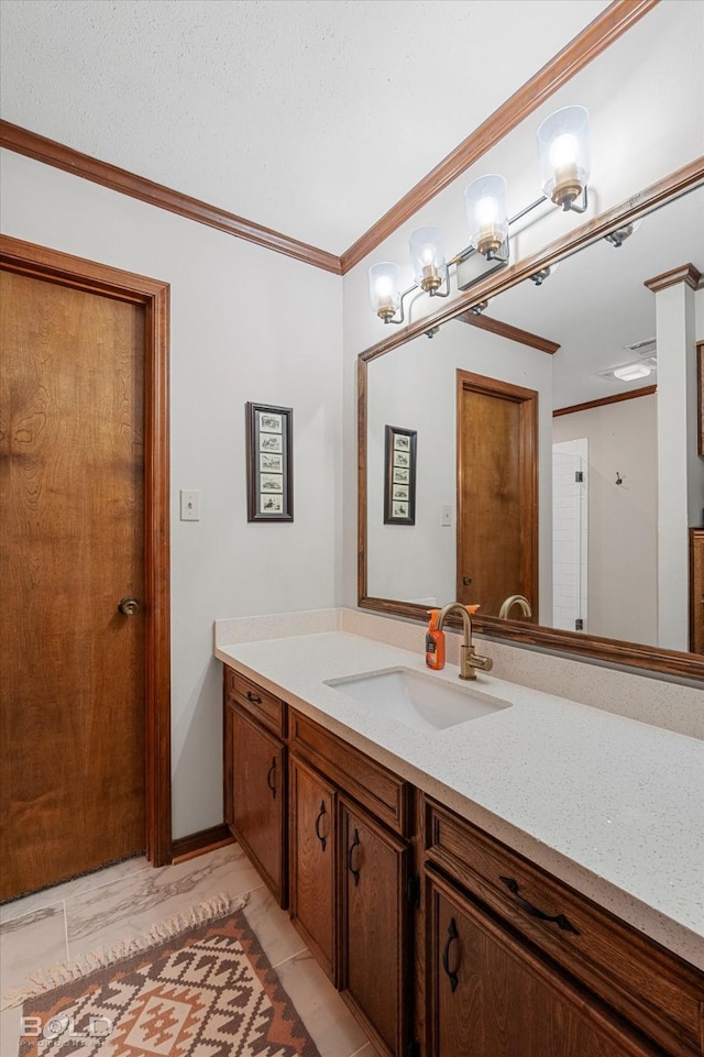 bathroom with crown molding, vanity, and marble finish floor