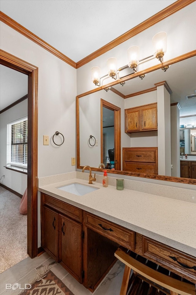bathroom featuring visible vents, ornamental molding, and vanity