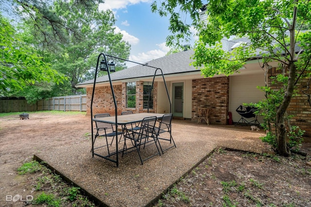 view of patio / terrace featuring fence, a fire pit, and outdoor dining space