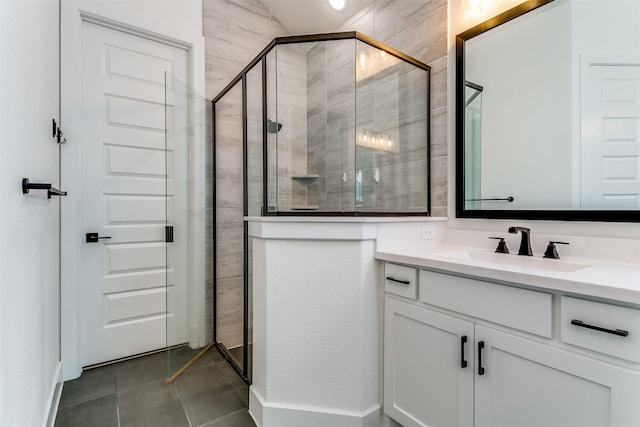 bathroom with a shower stall, tile patterned flooring, and vanity