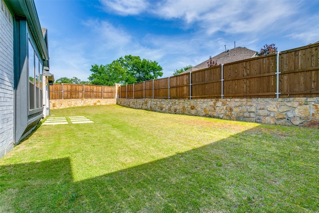view of yard with a fenced backyard
