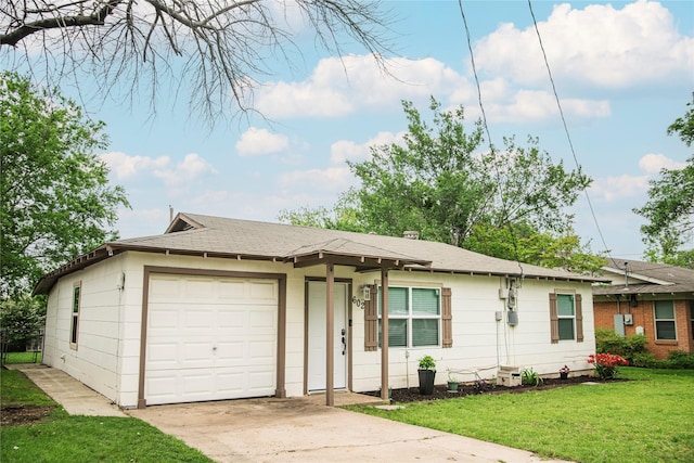 ranch-style house with fence, a shingled roof, a front lawn, a garage, and driveway