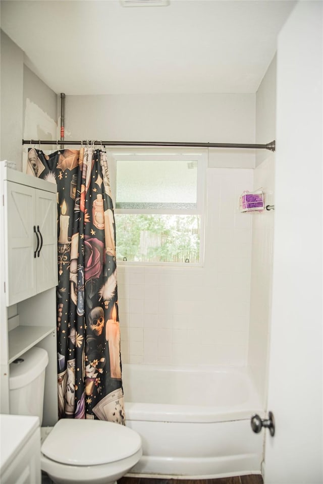 bathroom with toilet and shower / tub combo