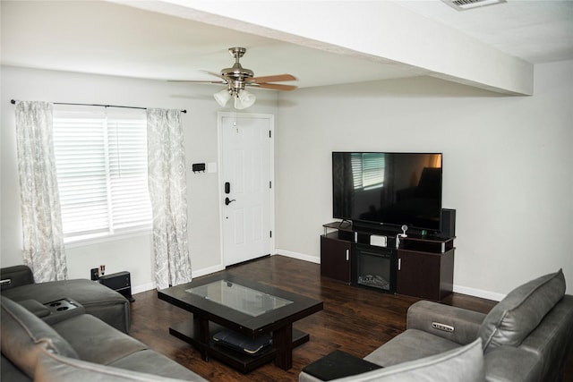 living room featuring baseboards, a ceiling fan, and wood finished floors