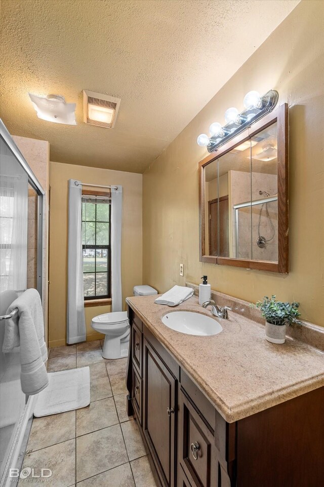 full bath featuring an enclosed shower, toilet, tile patterned flooring, and vanity