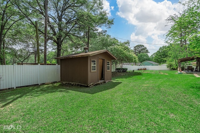 view of yard featuring a storage shed, an outbuilding, and a fenced backyard