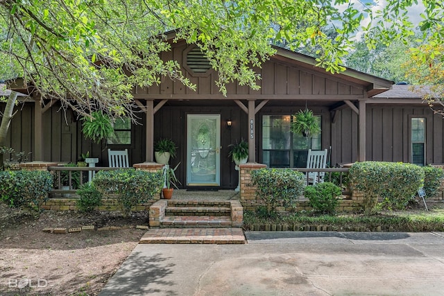 doorway to property featuring board and batten siding