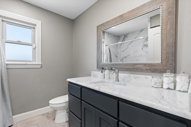 bathroom featuring vanity, toilet, tile patterned floors, baseboards, and curtained shower
