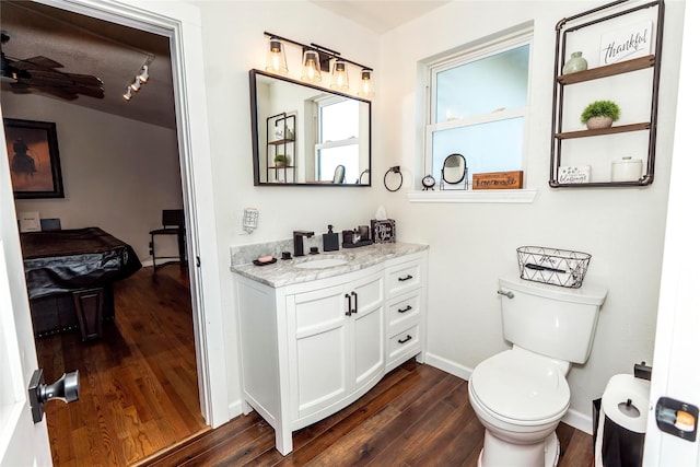 bathroom with vanity, toilet, baseboards, billiards, and wood finished floors