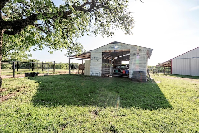 view of pole building with an exterior structure and fence