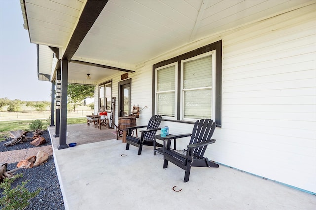view of patio / terrace with fence and covered porch