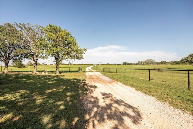 view of road with driveway and a rural view