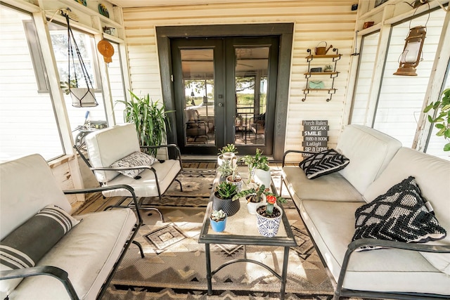 sunroom featuring plenty of natural light and french doors
