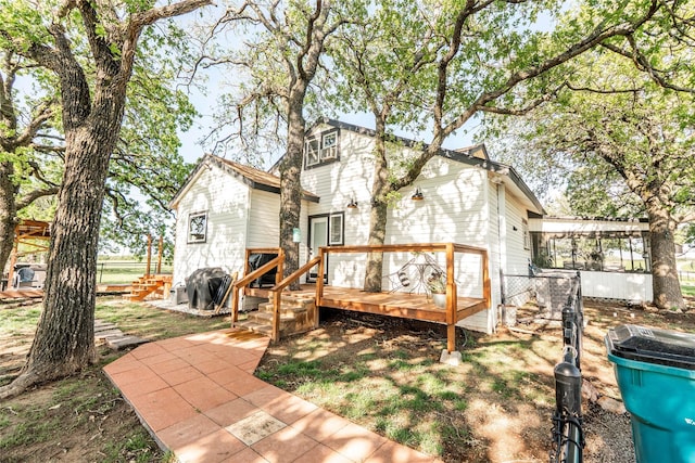 rear view of house with a wooden deck