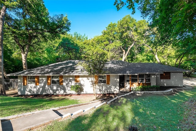 ranch-style home with brick siding and a front yard