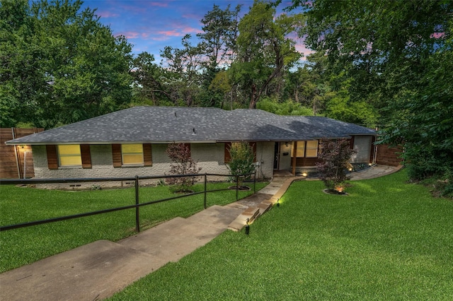 3467 Navajo Cir, Dallas, TX 75224 - ranch-style home featuring a fenced front yard, roof with shingles, and brick siding
