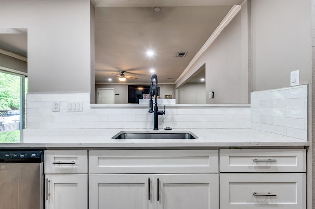 3467 Navajo Cir, Dallas, TX 75224 - kitchen featuring stainless steel dishwasher, ornamental molding, decorative backsplash, and white cabinetry